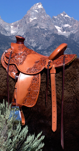 Light weight Lady's Wade Saddle with Custom copper rose and blue bells floral tooling with hand painted dyed background all dallied in a Vaquero Lace border. Contact us about a saddle made just for you like this one.